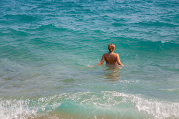Girl enter in the sea