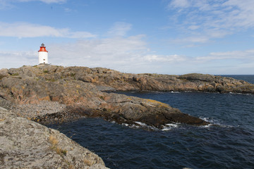 Fototapeta na wymiar Red lighthouse on the small island in front of Smughen 
