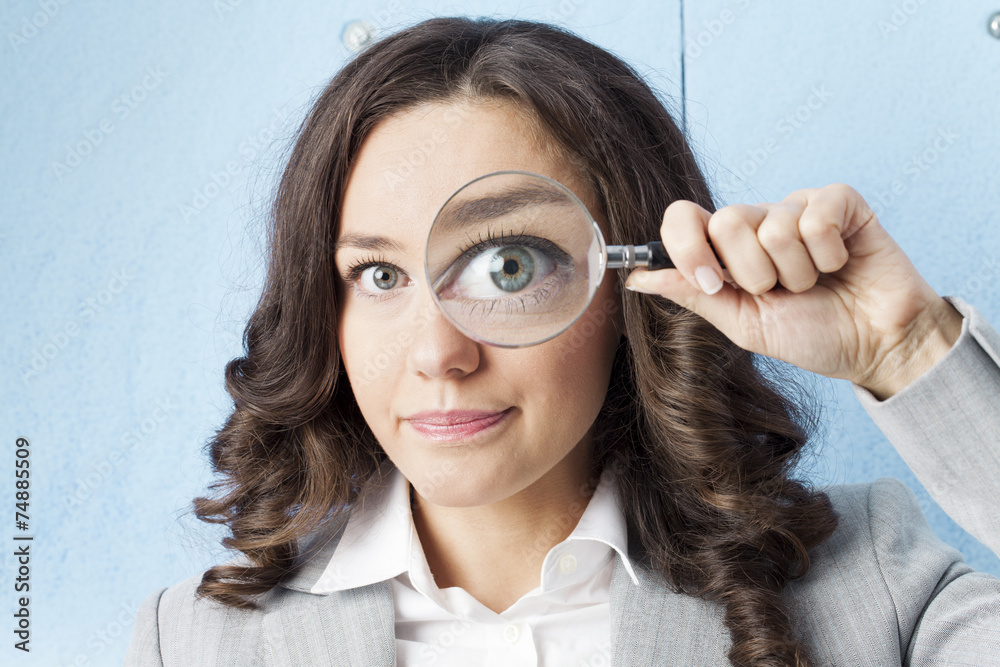 Wall mural woman with magnifying glass