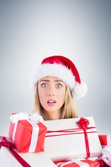 Festive blonde holding pile of gifts