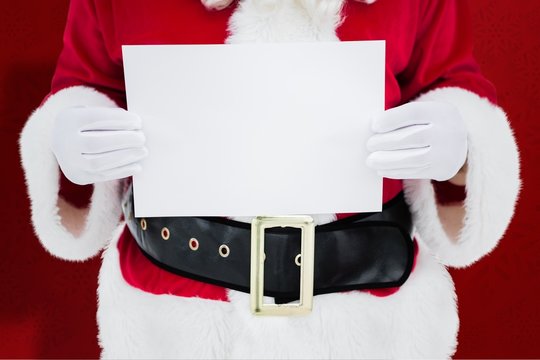 Composite image of mid section of santa claus holding page