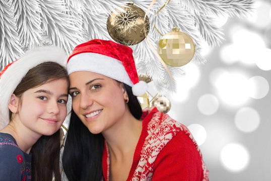 Composite image of mother and daughter in santa hats