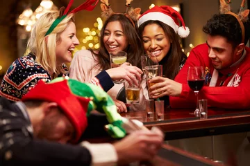 Papier Peint photo Bar Man Passed Out On Bar During Christmas Drinks With Friends