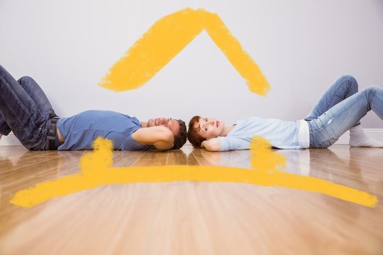 Composite Image Of Couple Lying On The Floor