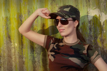 Young Woman Soldier in Camouflage Outfit Saluting