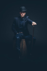 Retro fashion man with blue shirt, jacket, jeans and bow tie. We