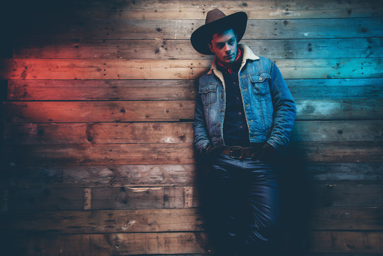 Winter cowboy jeans fashion man. Wearing brown hat, jeans jacket