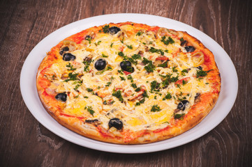 pizza with ham on white plate