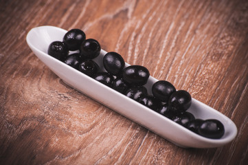 black olives  in white plate