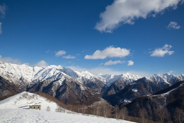 snowy mountains with clouds