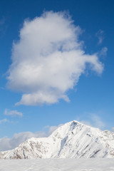 Fototapeta na wymiar snowy mountains with clouds