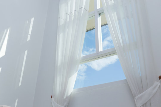 White Curtain On The Window With Blue Sky