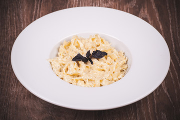 cream sauce pasta in white plate