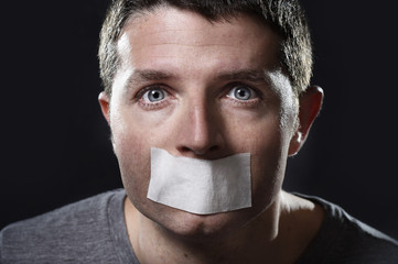 attractive man mouth sealed on tape freedom of speech concept