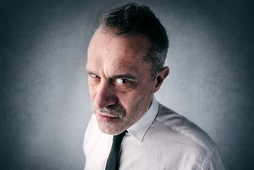 Fototapeta premium Angry businessman looking straight into the camera