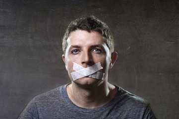 attractive man mouth sealed on tape freedom of speech concept