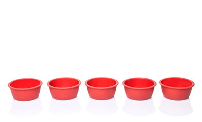 Red silicone muffin baking cup over white background