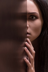 Beautiful young brunette woman looking scared.