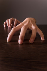 closeup on female hands on wooden table.