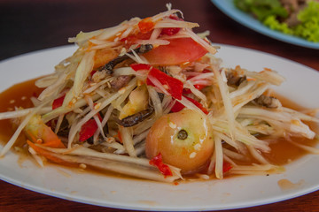 Som Tam is spicy green papaya salad Thai food.