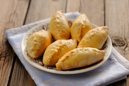 Russian pirogi, small pies on blue linen