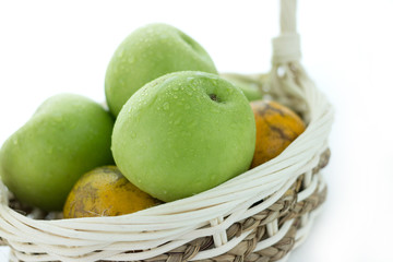basket of green apples on white background