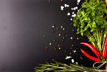 Herbs and spices. basil, red pepper, salt and rosemary on a blac