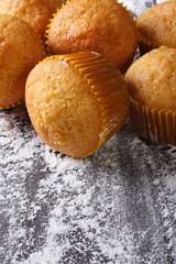 orange muffins and spilling flour,  top view vertical