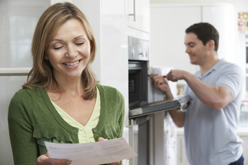 Satisfied Female Customer With Oven Repair Bill