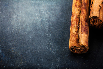 Сinnamon sticks close up on dark background with blank copyspac