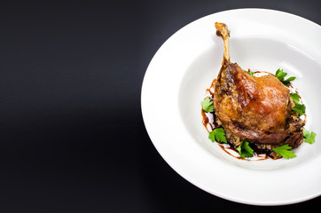 Roasted duck leg with herbs and red sauce  for Christmas in a wh