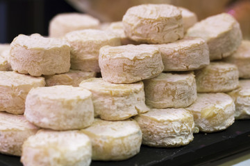 mature small goat cheese at the cheese monger