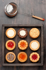 Сookies with chocolate and jam in a wooden box