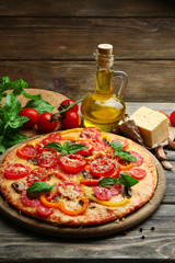 Delicious pizza served on wooden table