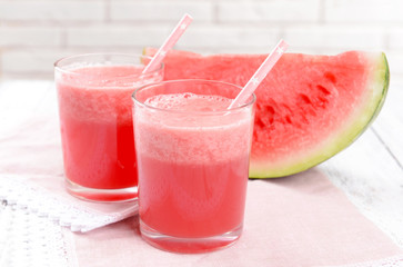 Juicy watermelon on table on brick wall background
