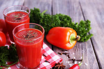 Tomato juice in glasses and fresh vegetables