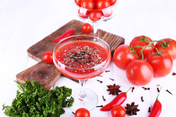 Tomato juice in goblet and fresh vegetables