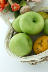 basket of green apples on white background