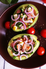 Tasty salad in avocado on plate table close-up