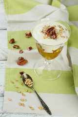 Tasty dessert with oat flakes and honey, on table