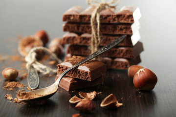 Tasty porous chocolate with nuts on table, close up