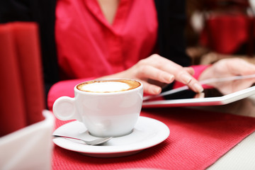 Woman with tablet computer in cafe shop