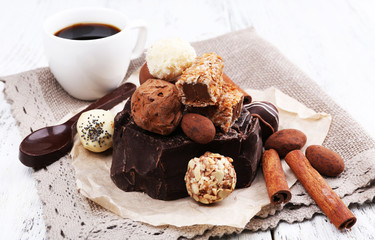 Pile of chunk of chocolate and truffles with cinnamon stick