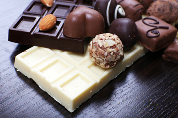 Bars of white and bitter chocolates with candies, cinnamon