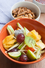 Delicious fruits salad in plate on table close-up