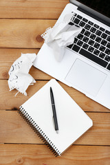 Diary with crumbled papers near the notebook