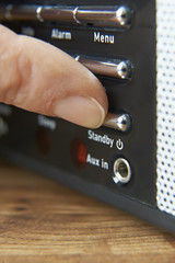 Close Up Of Woman Pressing Standy Button On Radio