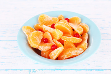 Bowl of slices mandarin with currants