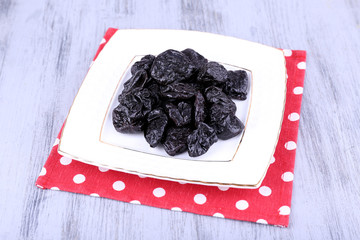 Squared white plate of prunes