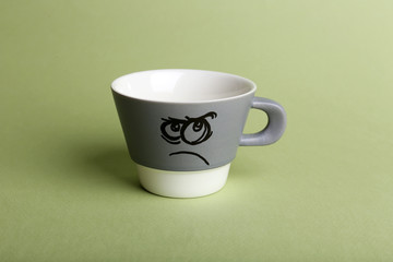 Emotional cup on green background